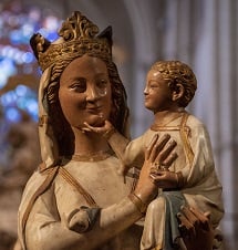 A statue of Mother Mary holding Jesus Christ, while they both smile