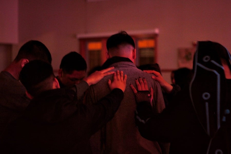 Group praying over man