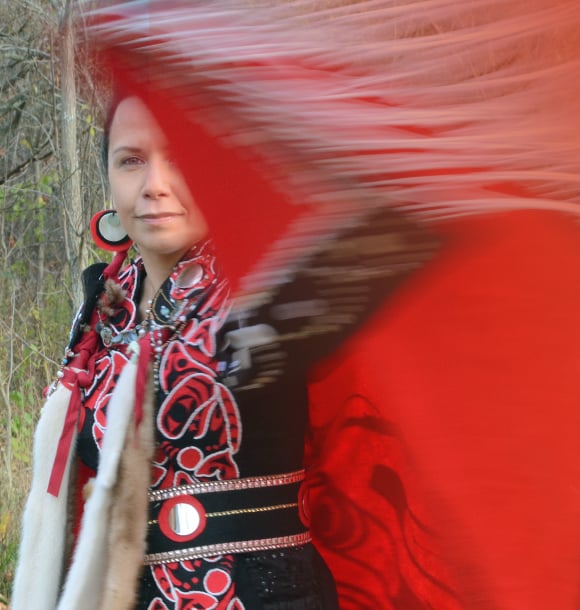 An Indigenous woman dancing