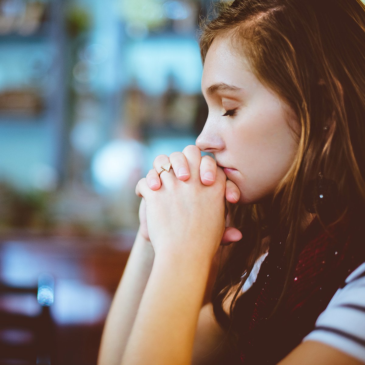 Girl praying with her eyes closed