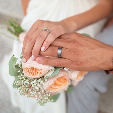 A couple holds hands on their wedding day