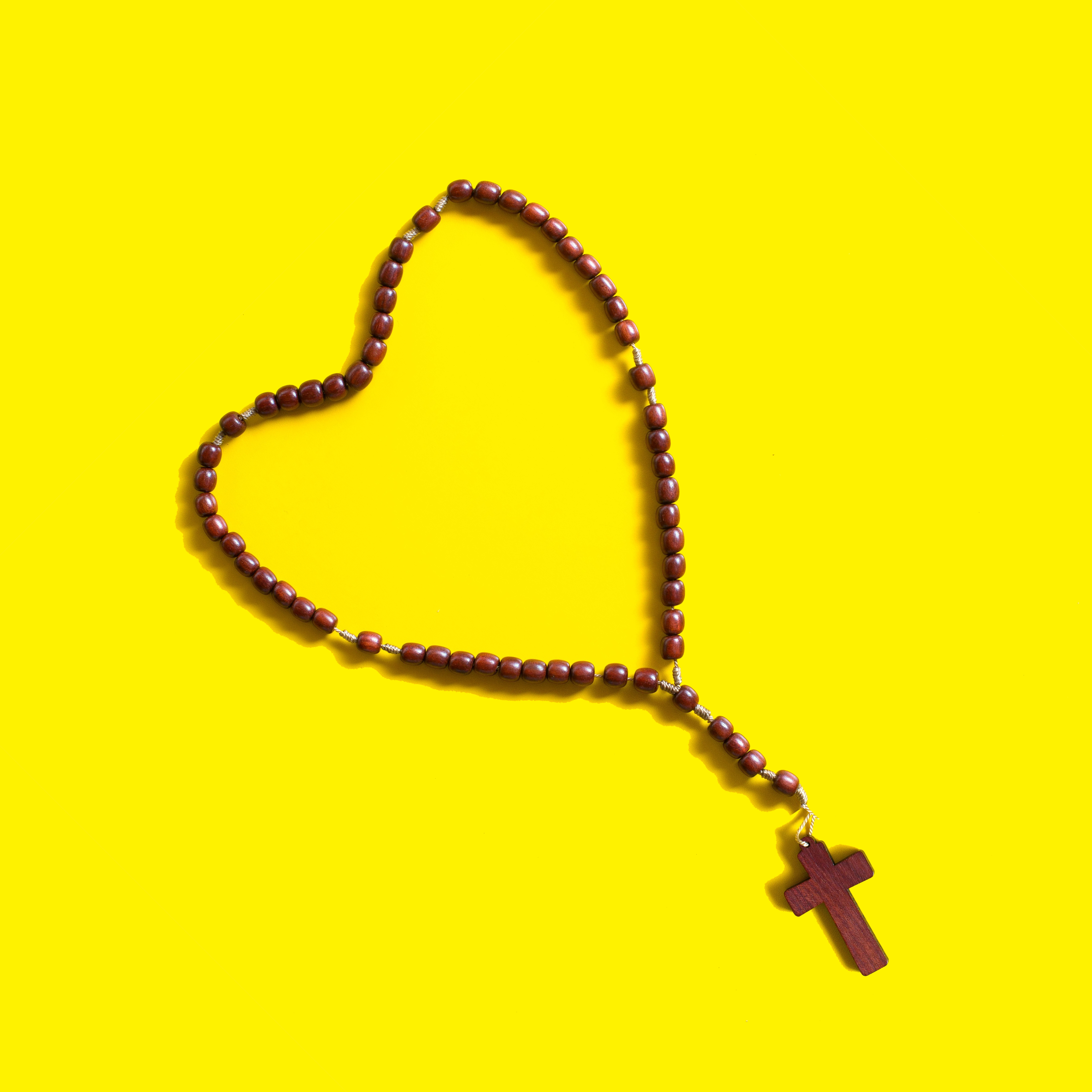 Photo of a Rosary laying in the shape of a heart