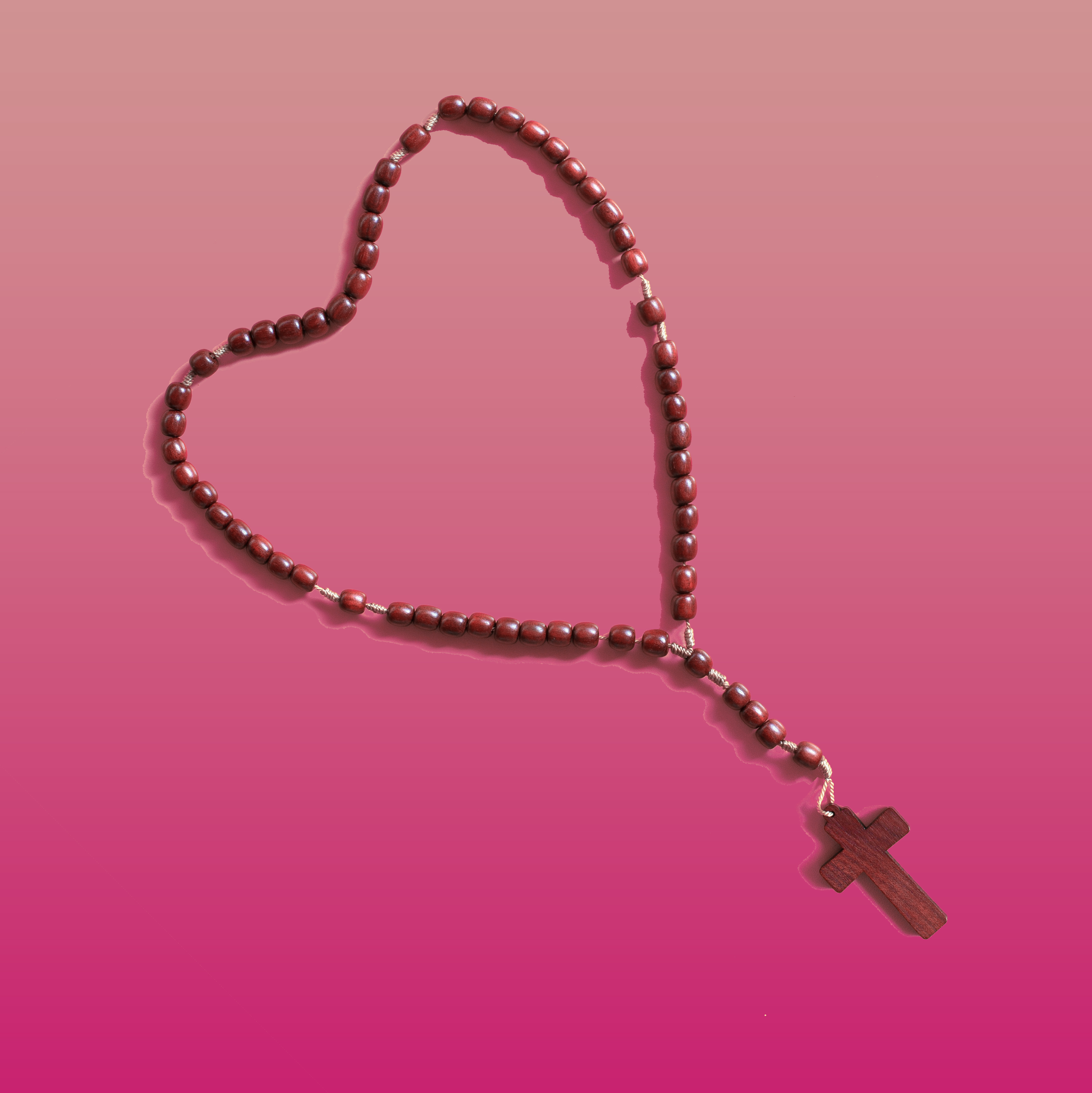 Photo of a rosary laid in the shape of a heart