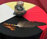 A table with the four directions cloth and smudging materials on top