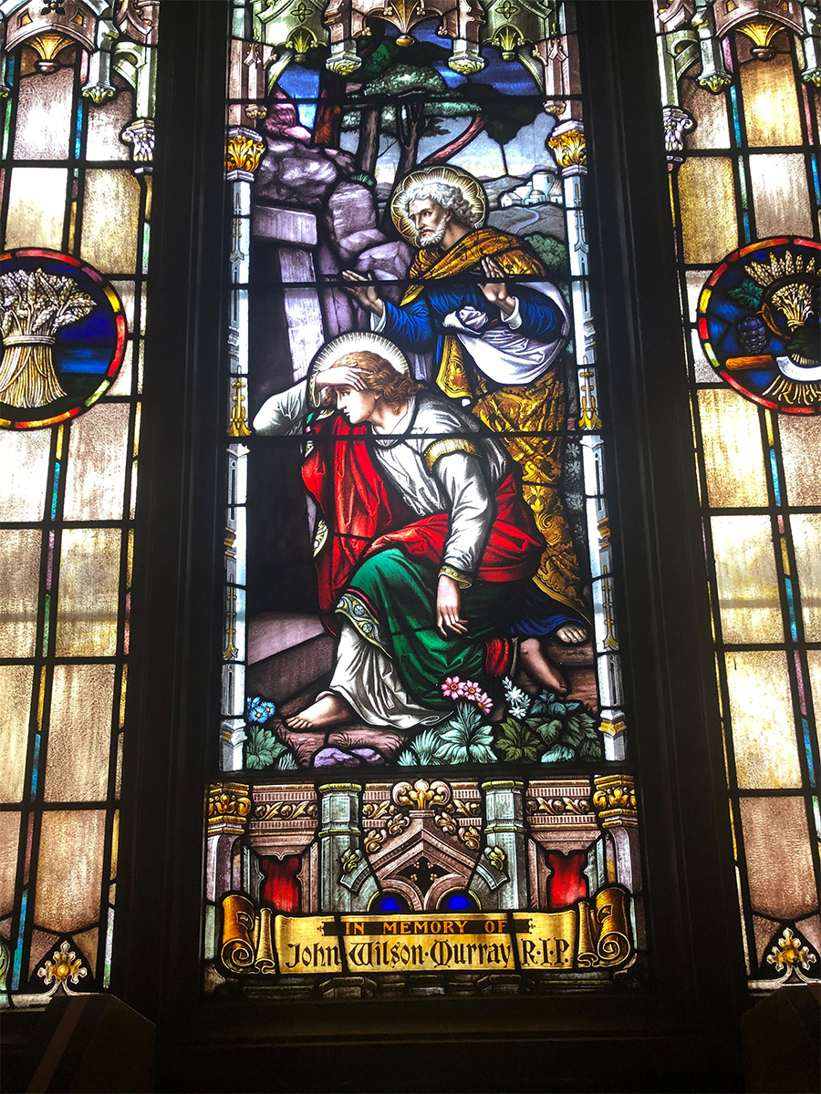 A stained glass window at St. Peter's Parish depicting Peter and John seeing Jesus' empty tomb