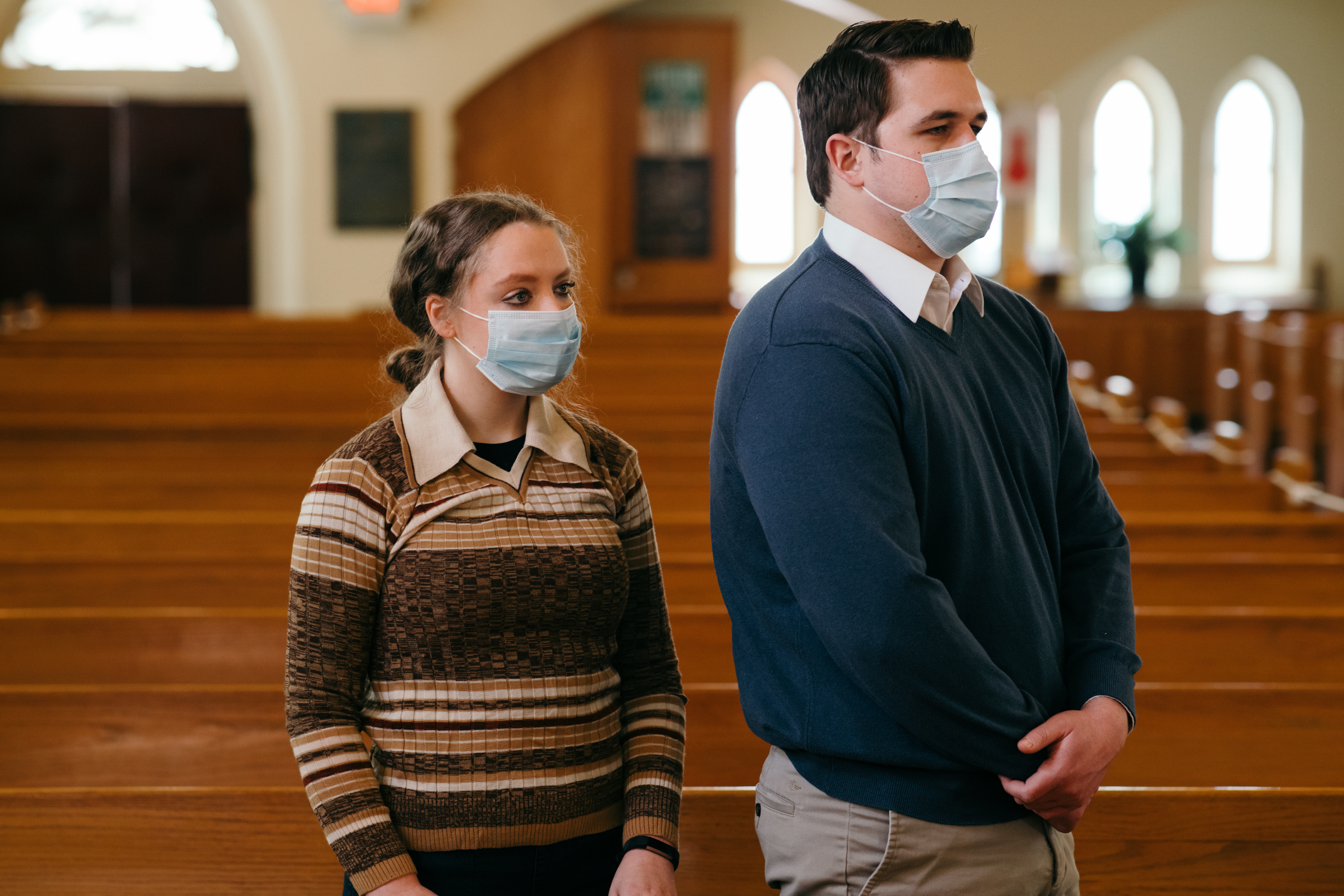 Couple in  church wearing masks