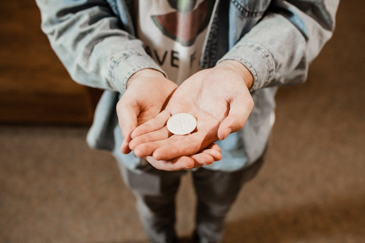 A man in jeans receiving the Eucharist
