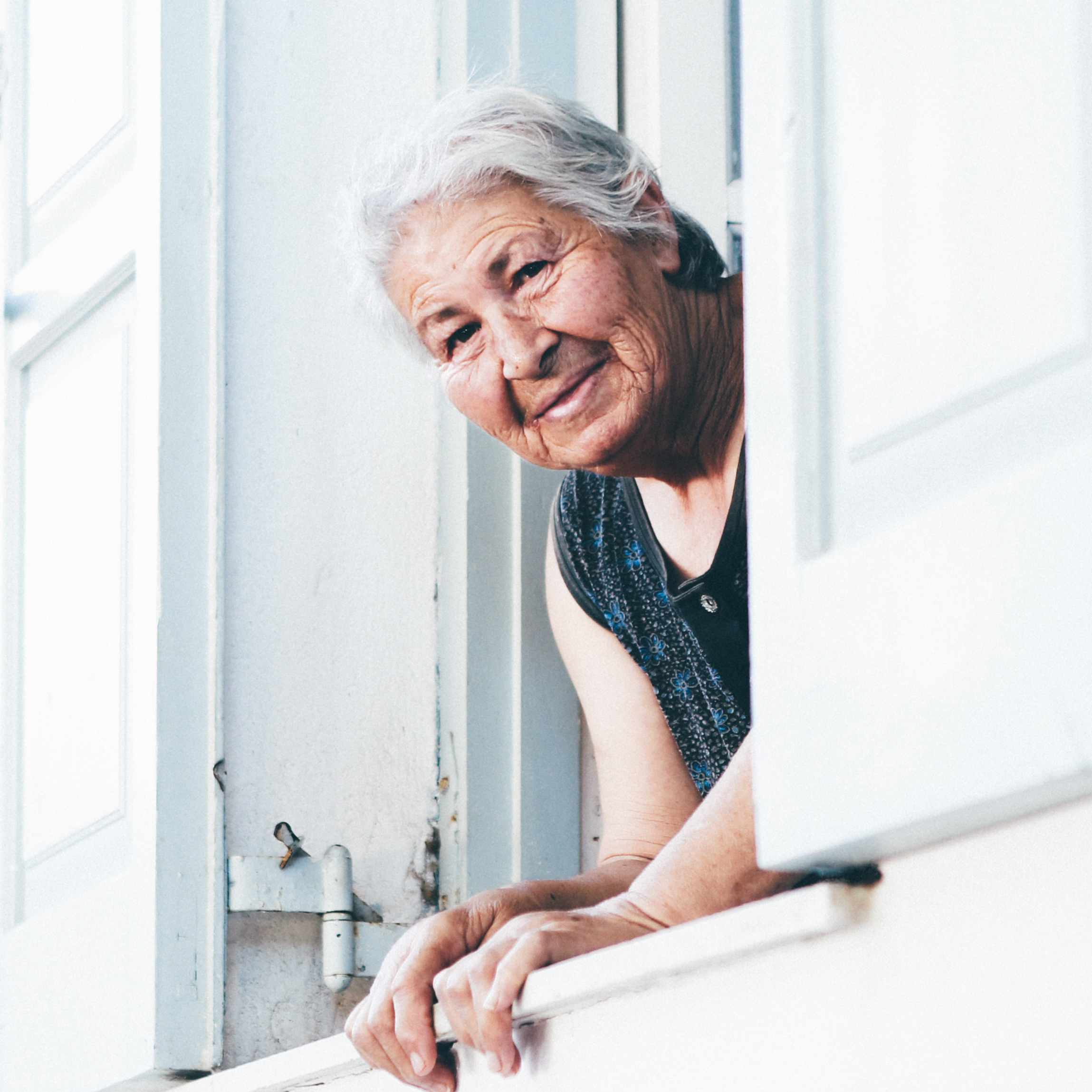 Elderly Lady Looking Out Window