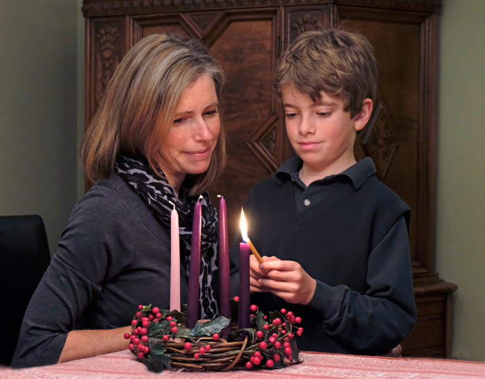 Child lighting an Advent candle