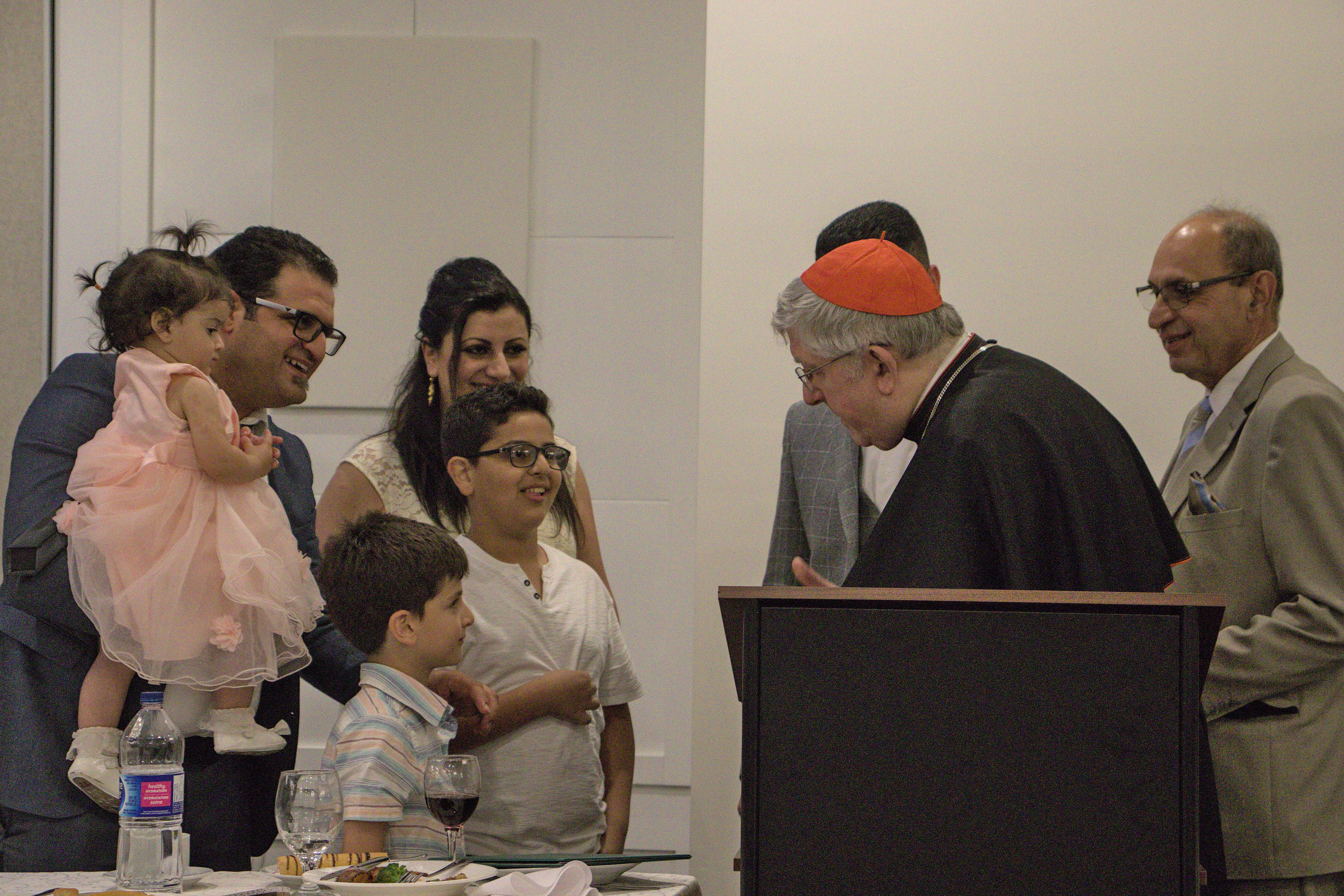 Cardinal Collins speaking to a family