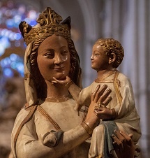 A statue of Mother Mary holding Jesus Christ, while they both smile