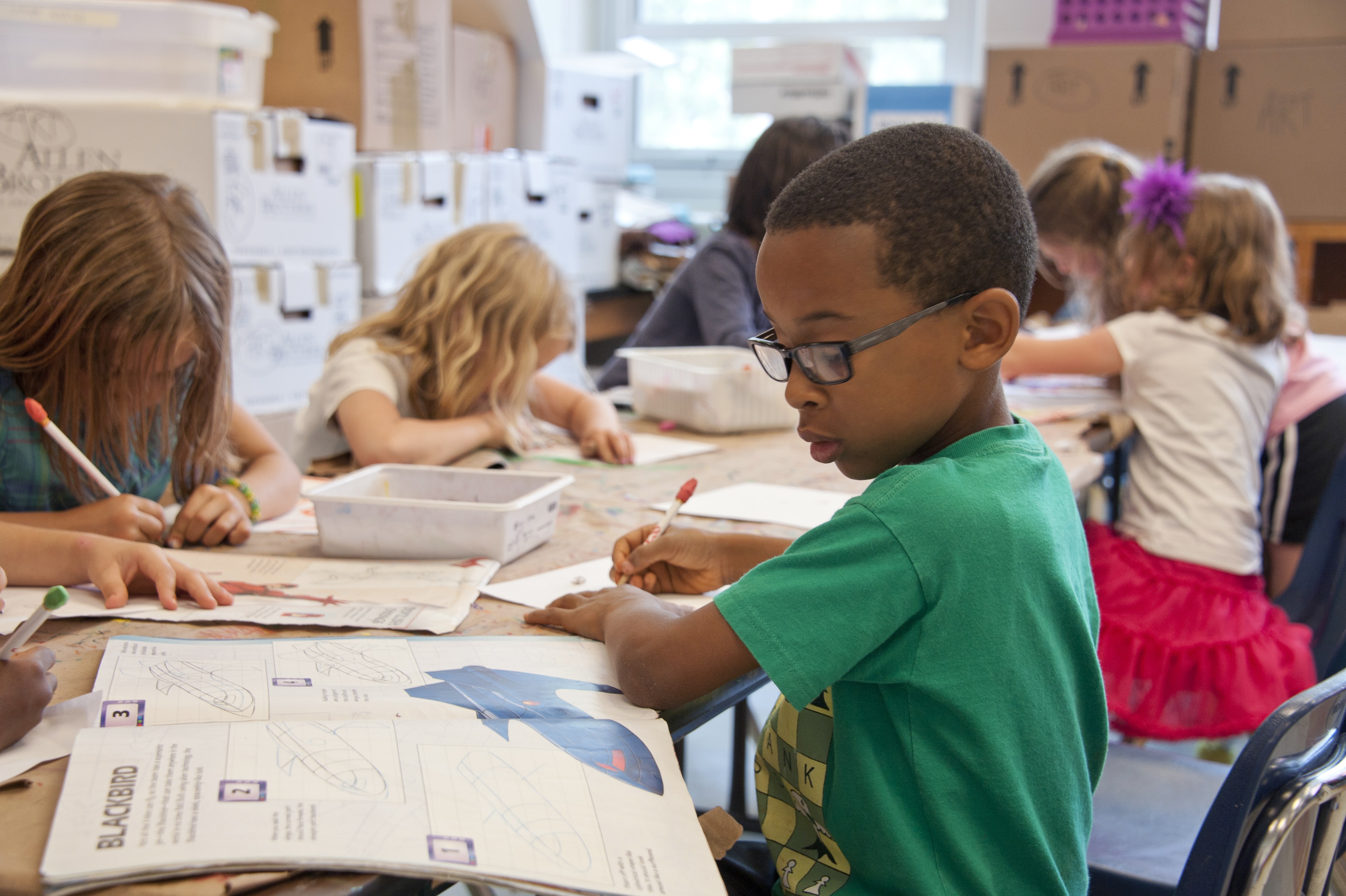 Happy students colouring in a classroom