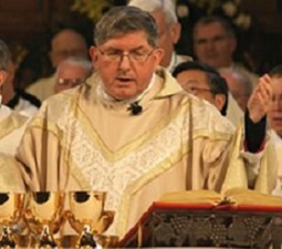 Cardinal Thomas Collins prays at the altar of St. Michael's Cathedral during his installation Mass as Archbishop of Toronto