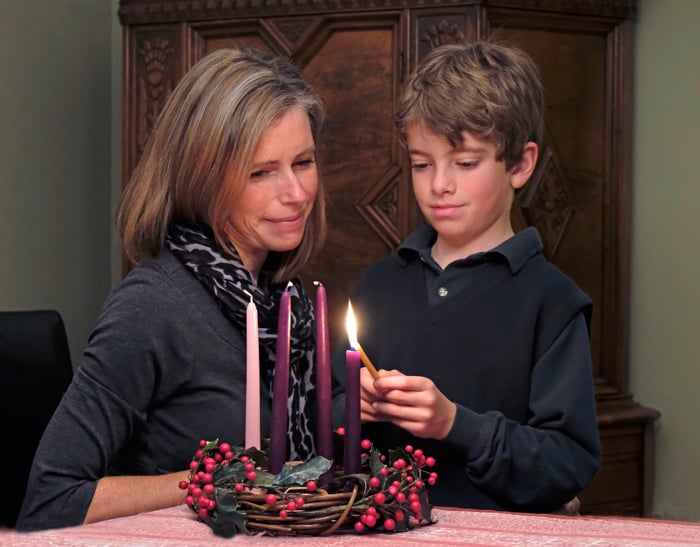 Child lighting an Advent candle