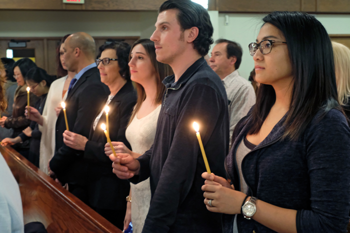 Group holding candles at church