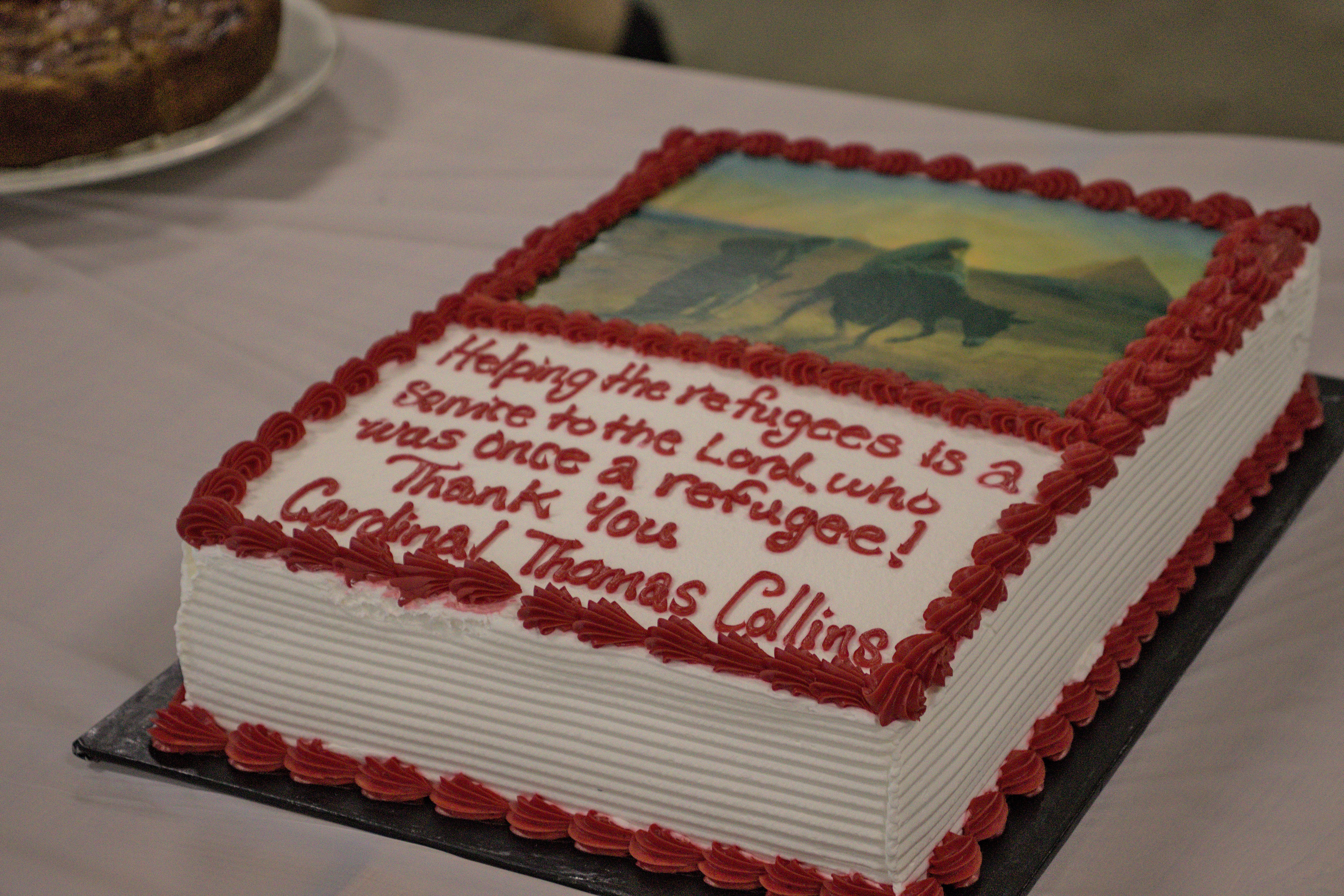 Photo of a cake thanking Cardinal Collins for helping refugees