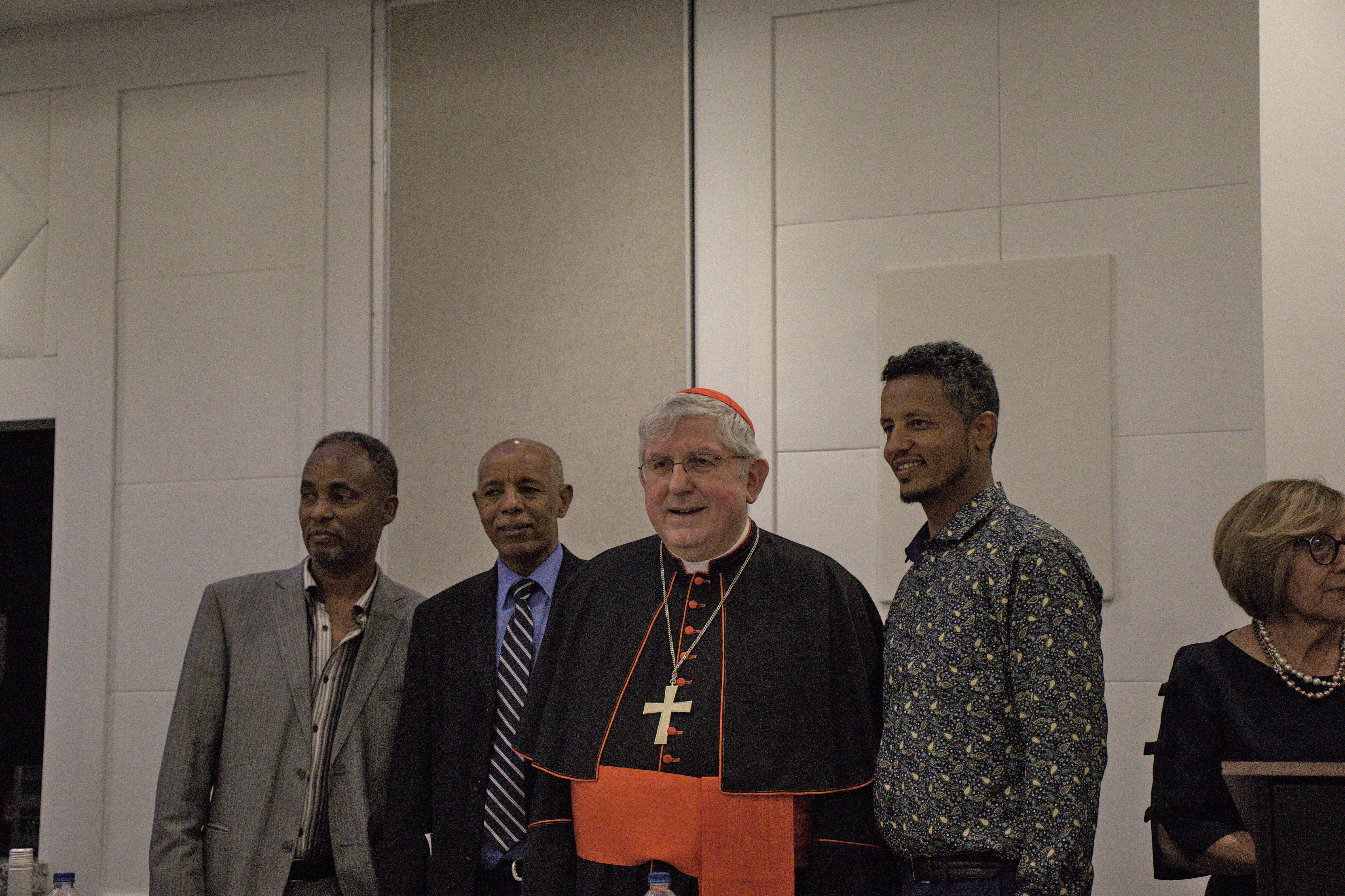 A group taking a photo with the Cardinal