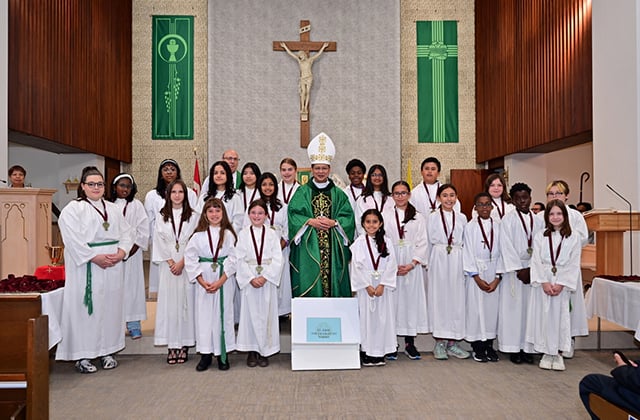 Bishop Nguyen with altar servers from St. John the Evangelist Parish