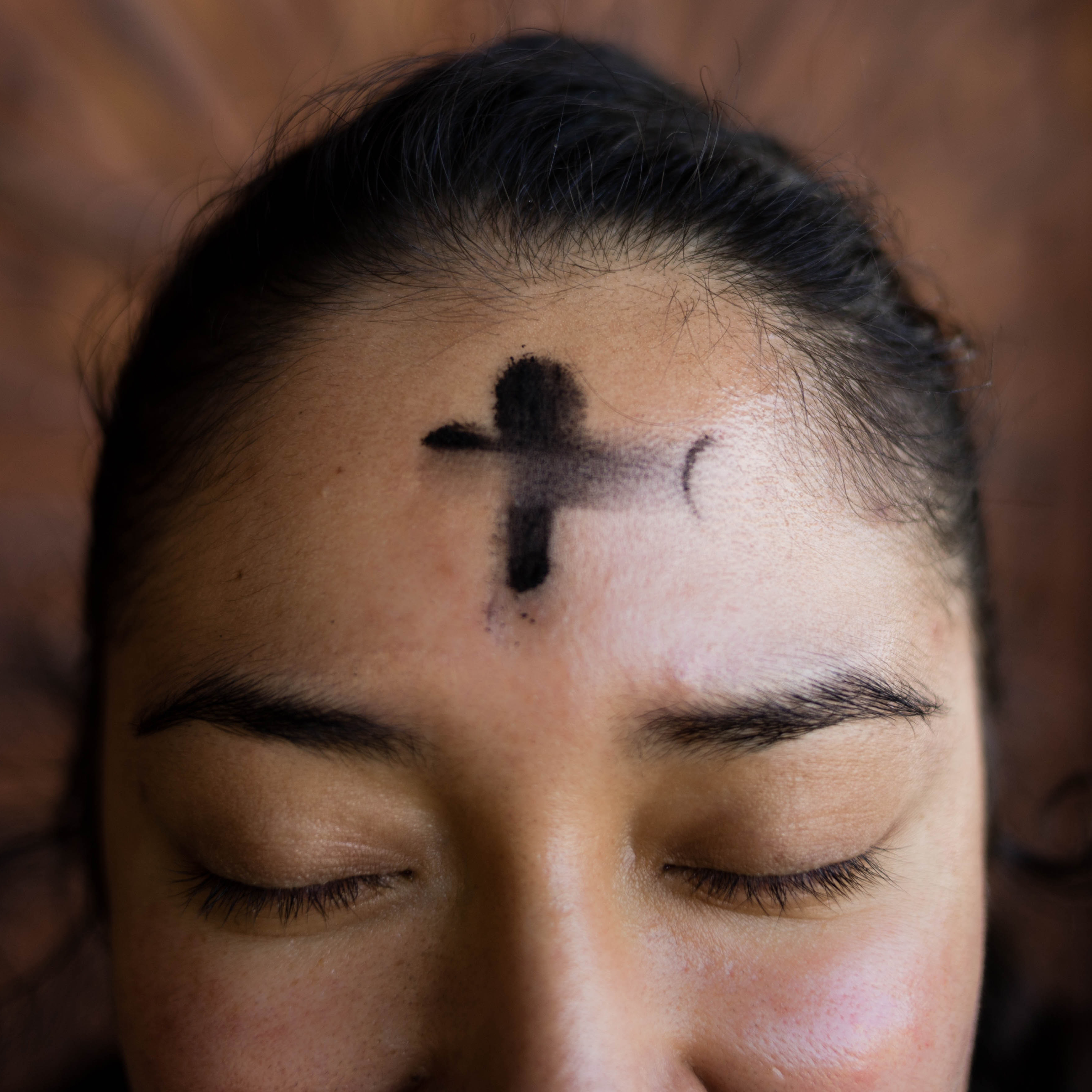 Photo of a lady with ashes on her forehead