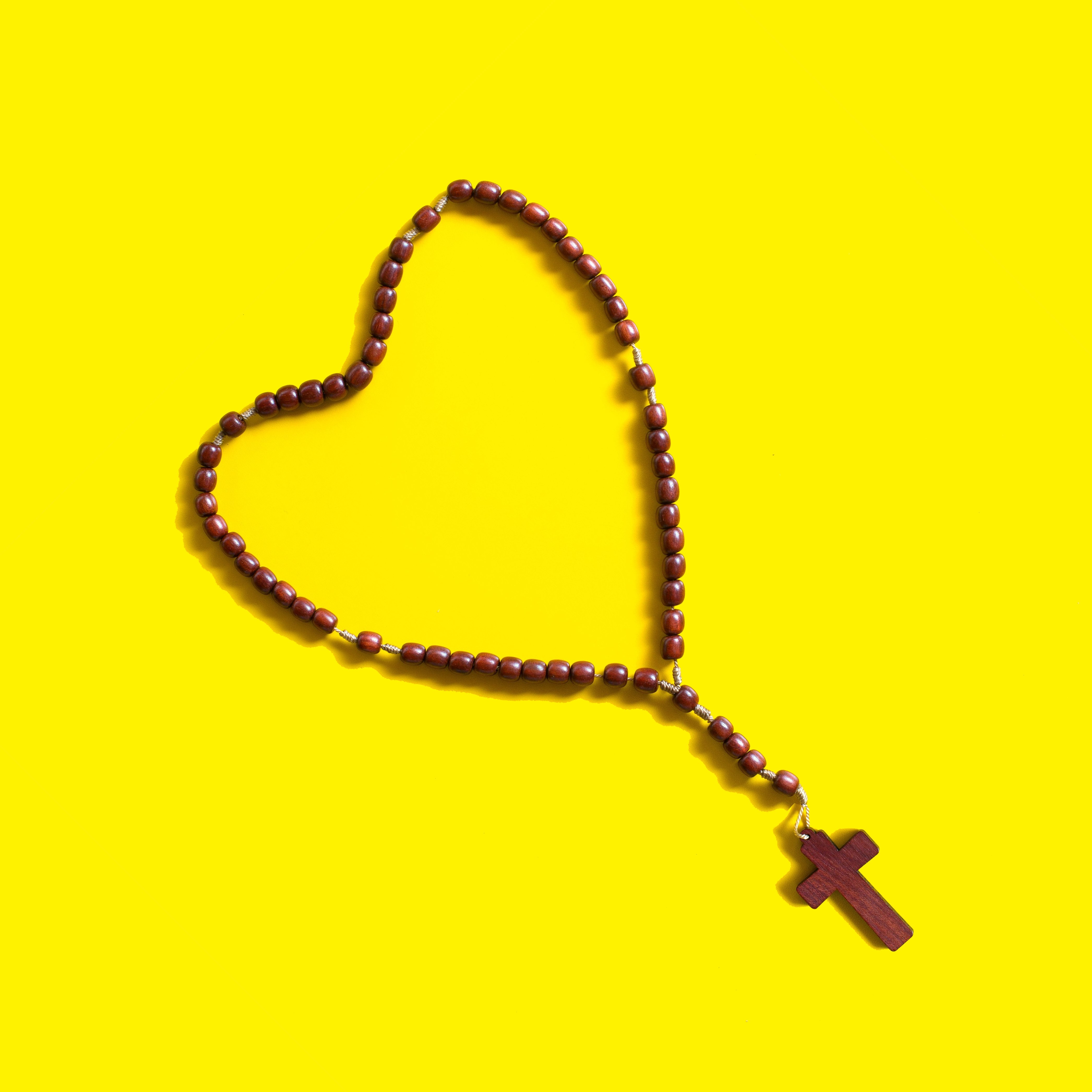 Rosary laying in the shape of a heart