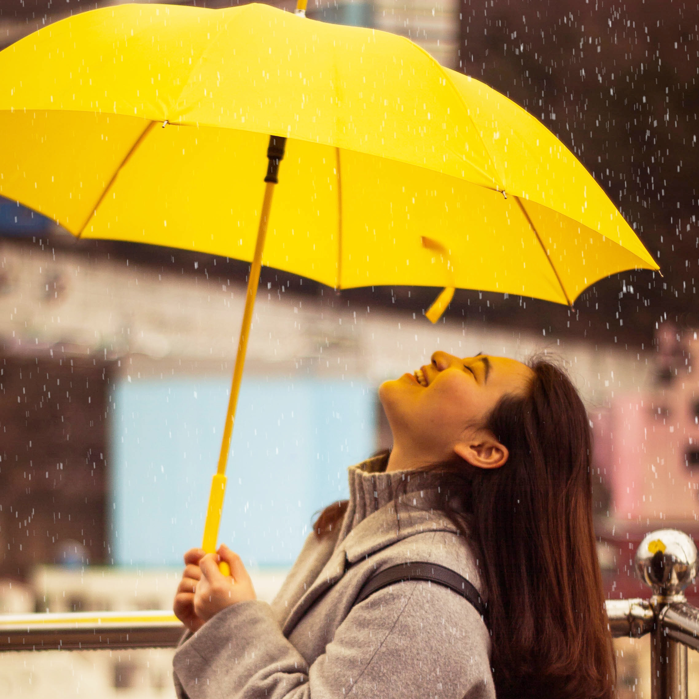 Lady smiling under an umbrella