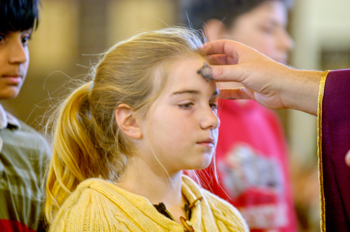 Girl receiving ashes on Ash Wednesday