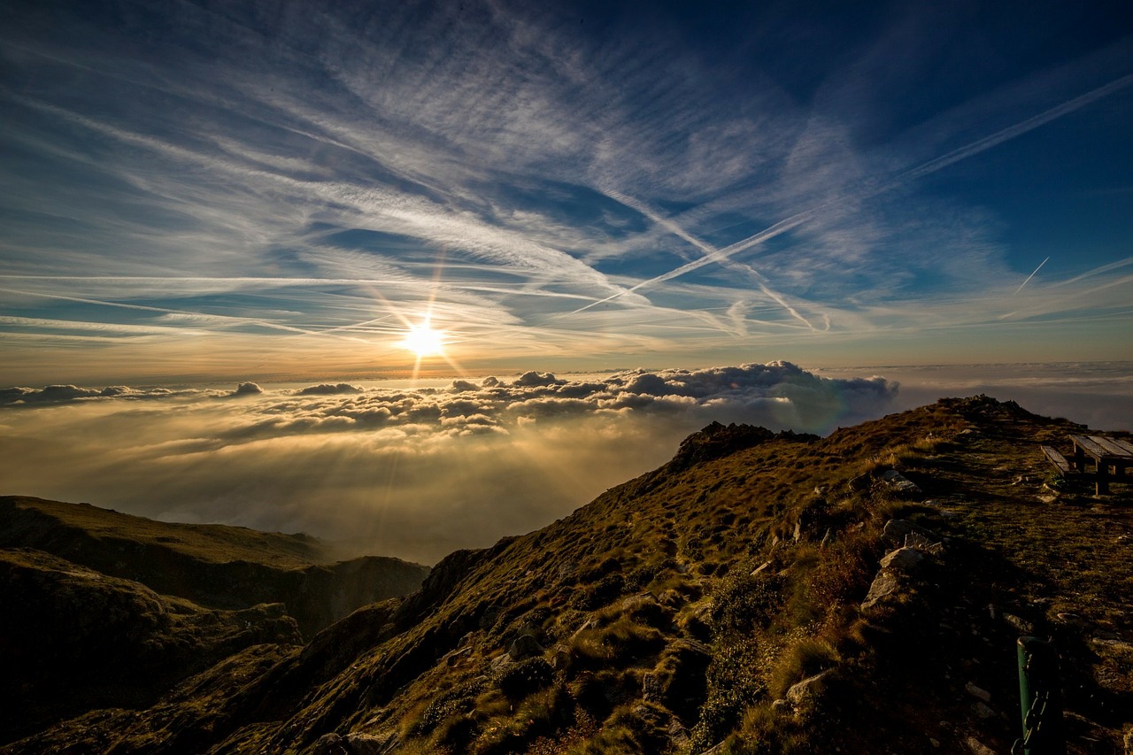 Scene of sun setting by mountains