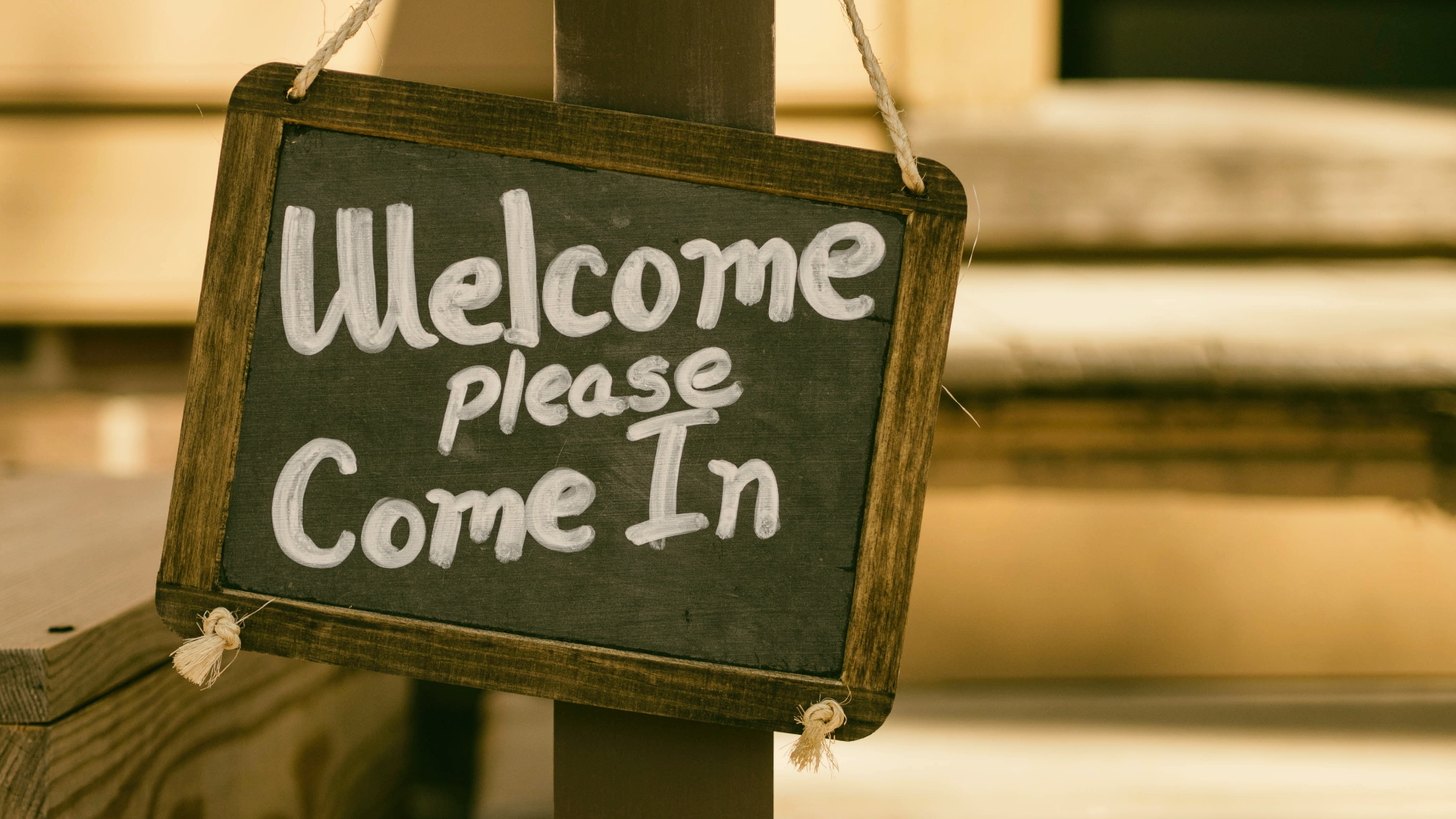 A sign with the text "Welcome, please come in."