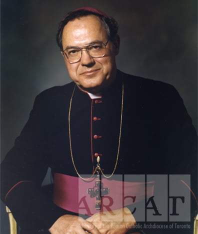 Portrait of His Eminence, Aloysius Matthew Cardinal Ambrozic seated wearing the purple colour of a bishop.