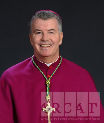 Portrait of Most Reverend William McGrattan standing, wearing episcopal dress.