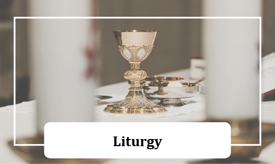 altar with two candles, image focuses on ciborium with the Eucharist