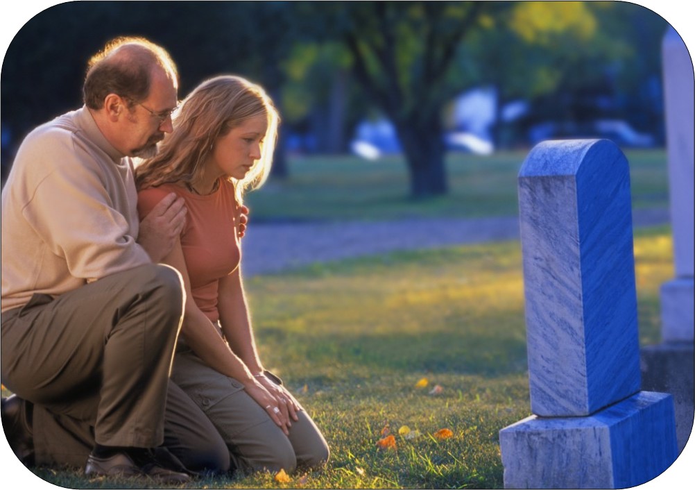 Image of man and woman kneeling at grave