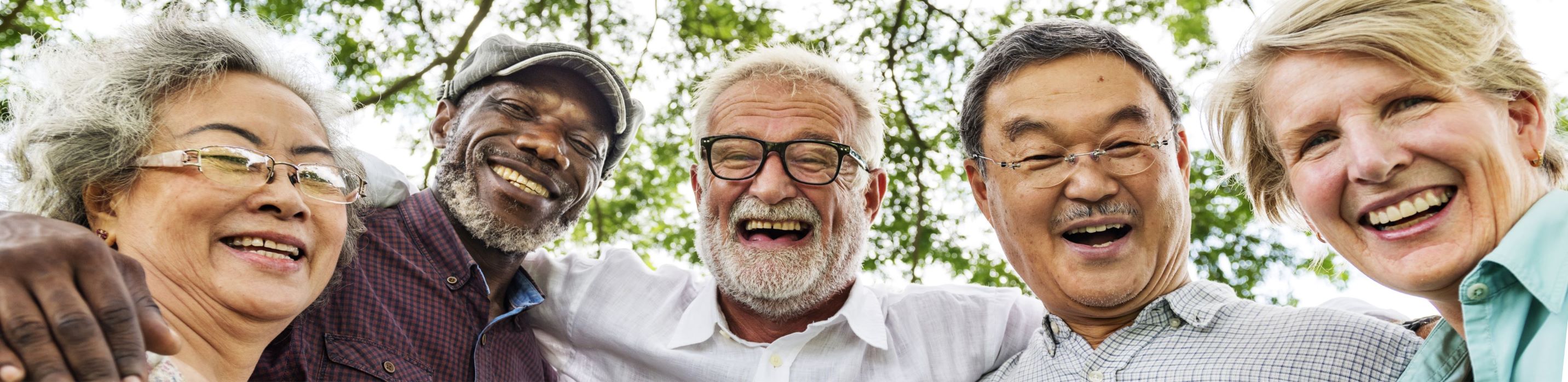 older men and women arm-in-arm smiling