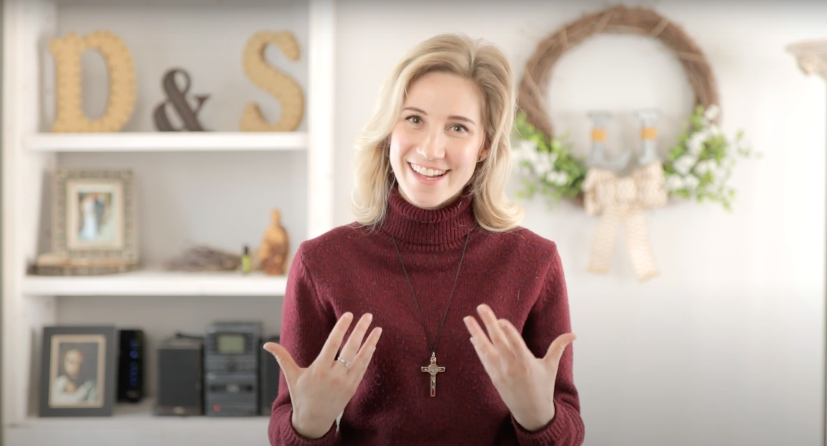 Young woman expressing her excitement by smiling and moving her hands towards her heart