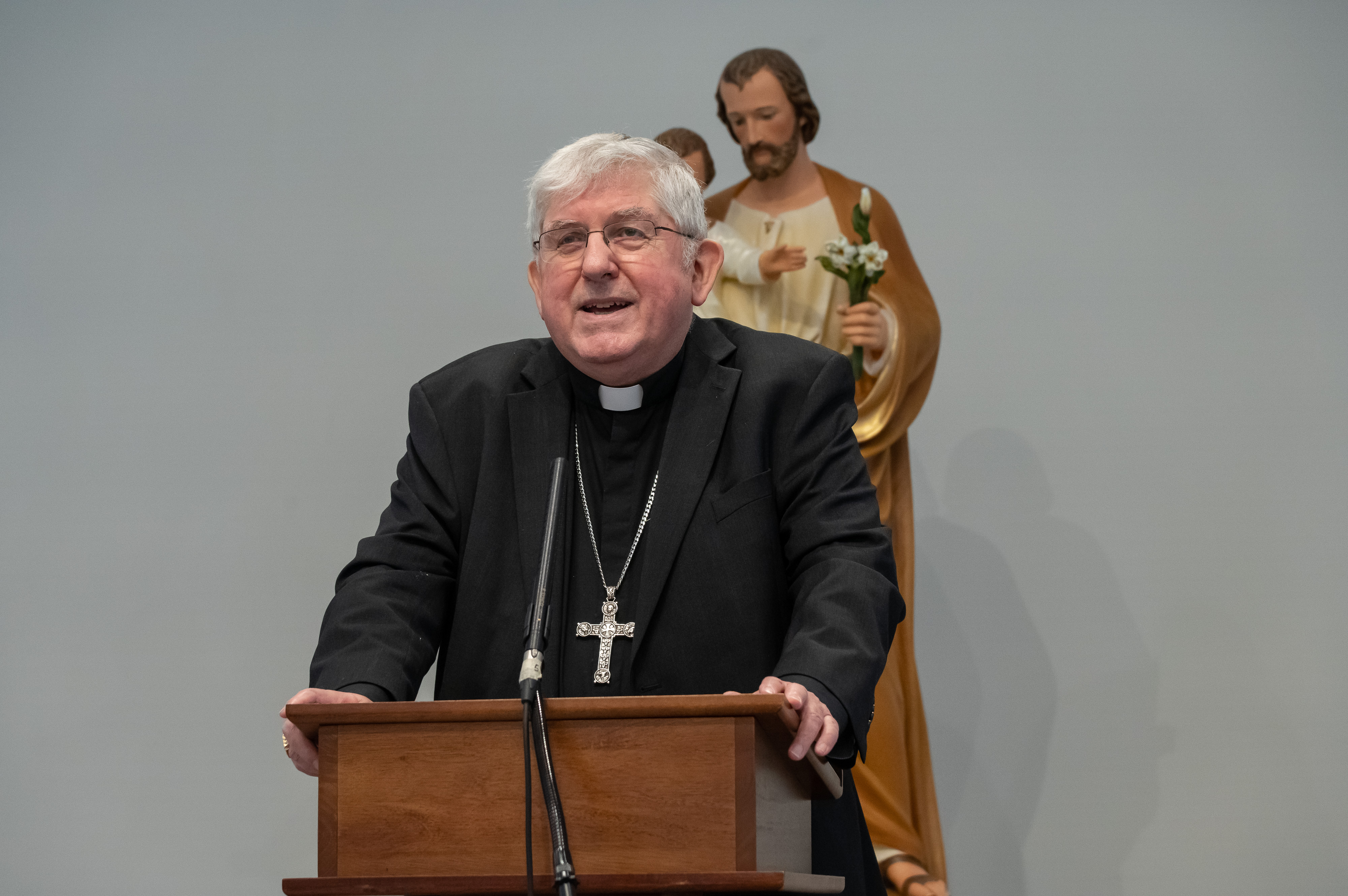 Cardinal Collins speaking at a podium