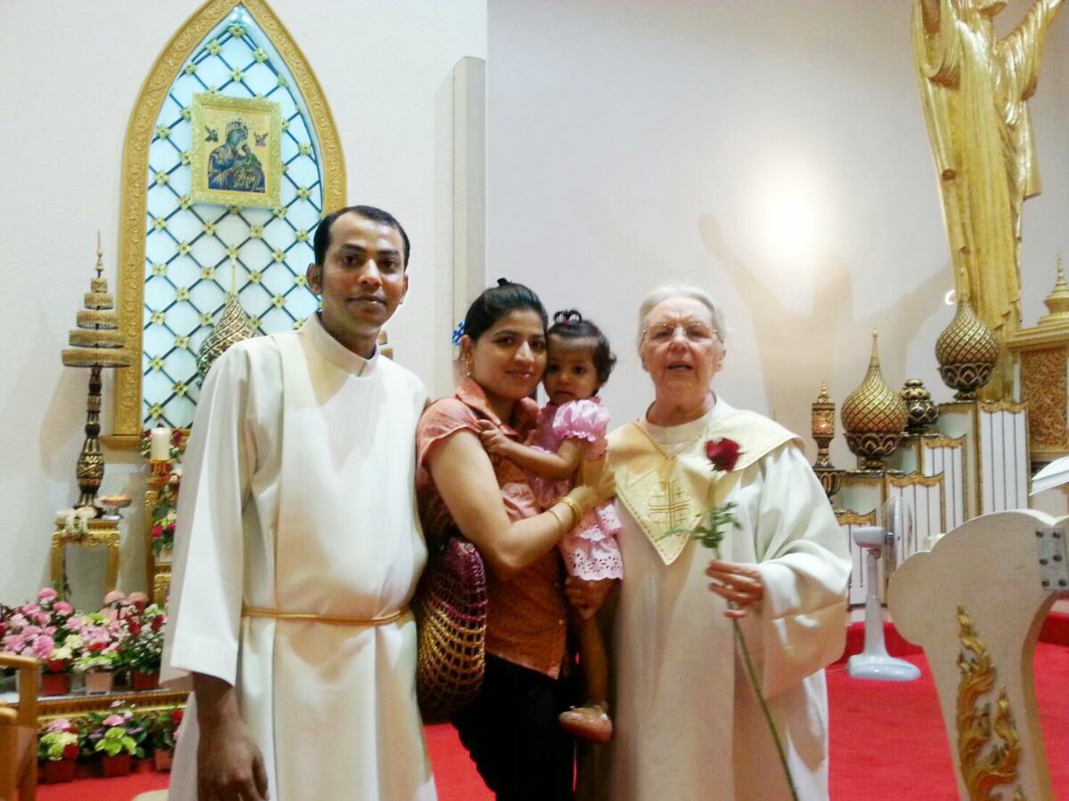 A group of newcomers headed for a local parish gather in a church