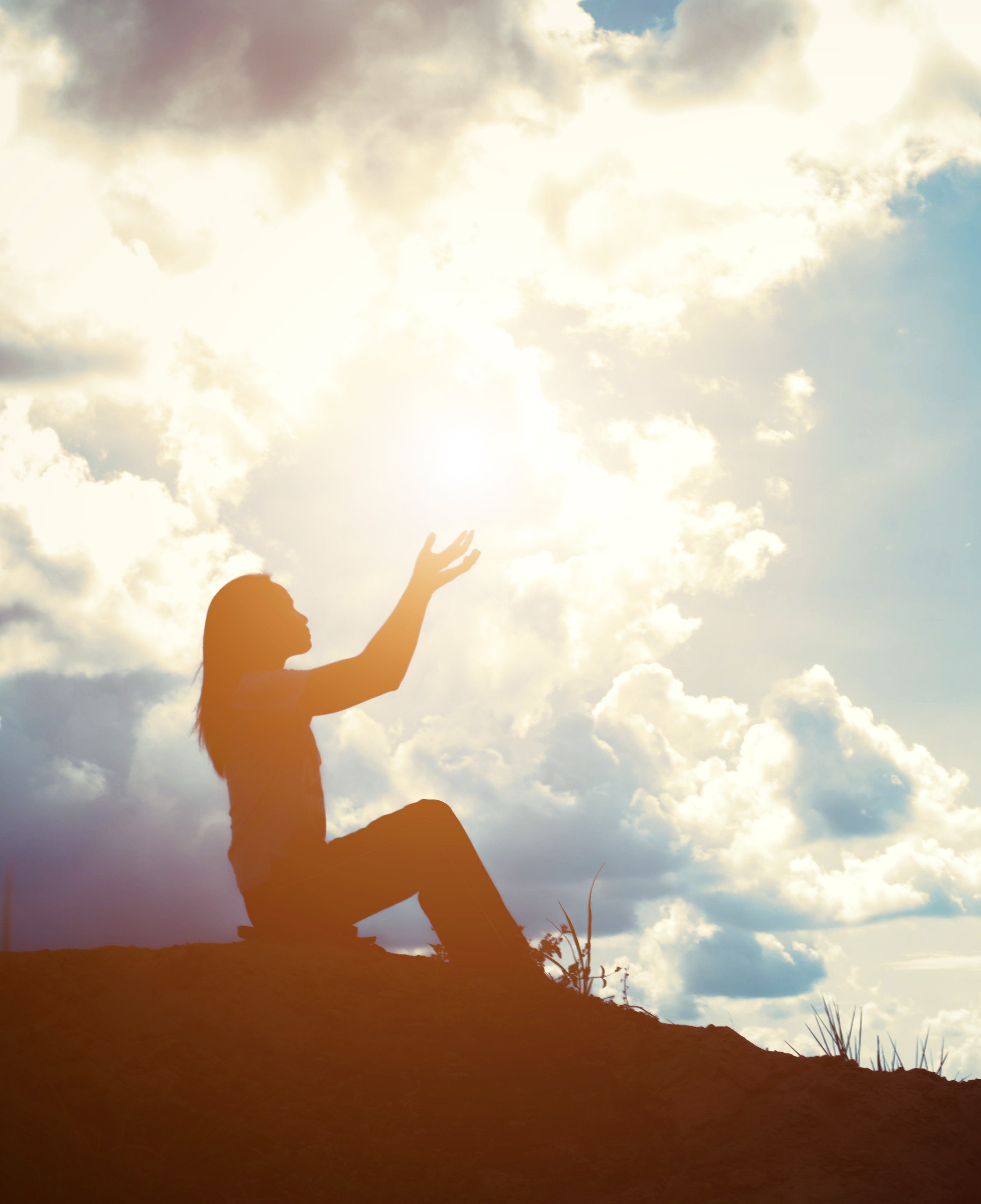 Silhouette of woman with raised hands 2