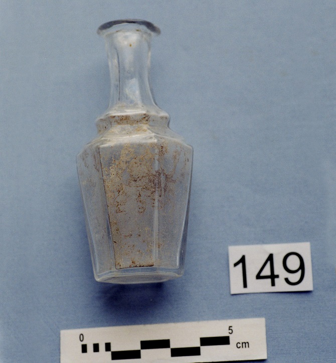 Small glass bottle caked with dirt on the inside