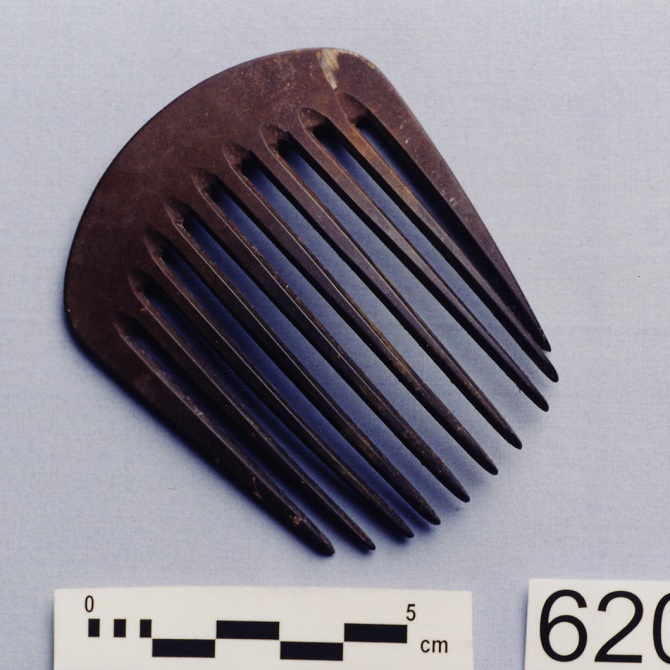 A small brown wooden hair comb