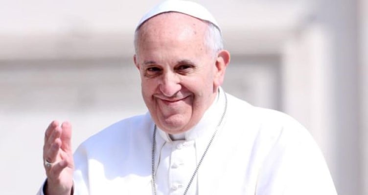 Pope Francis smiling and waving to audience