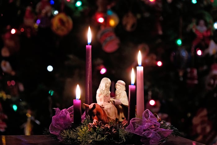 Four Advent candles at home with figurines